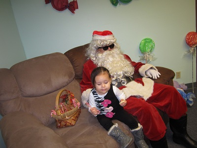 Santa posing with a small child